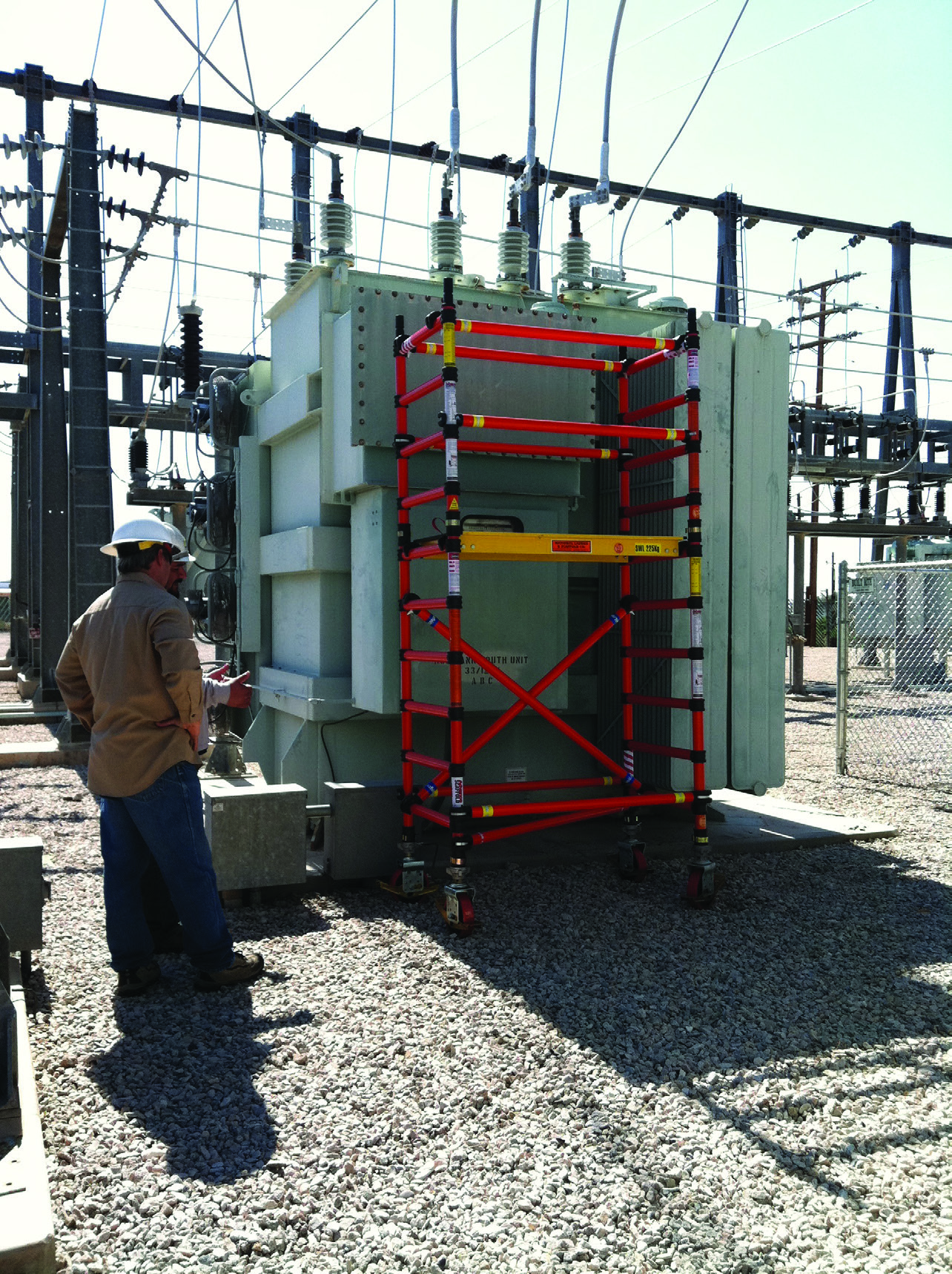 Fiberglass tower positioned beside outdoor electrical equipment