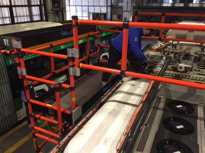 Fiberglass access platform alongside bus rooftop equipment during maintenance