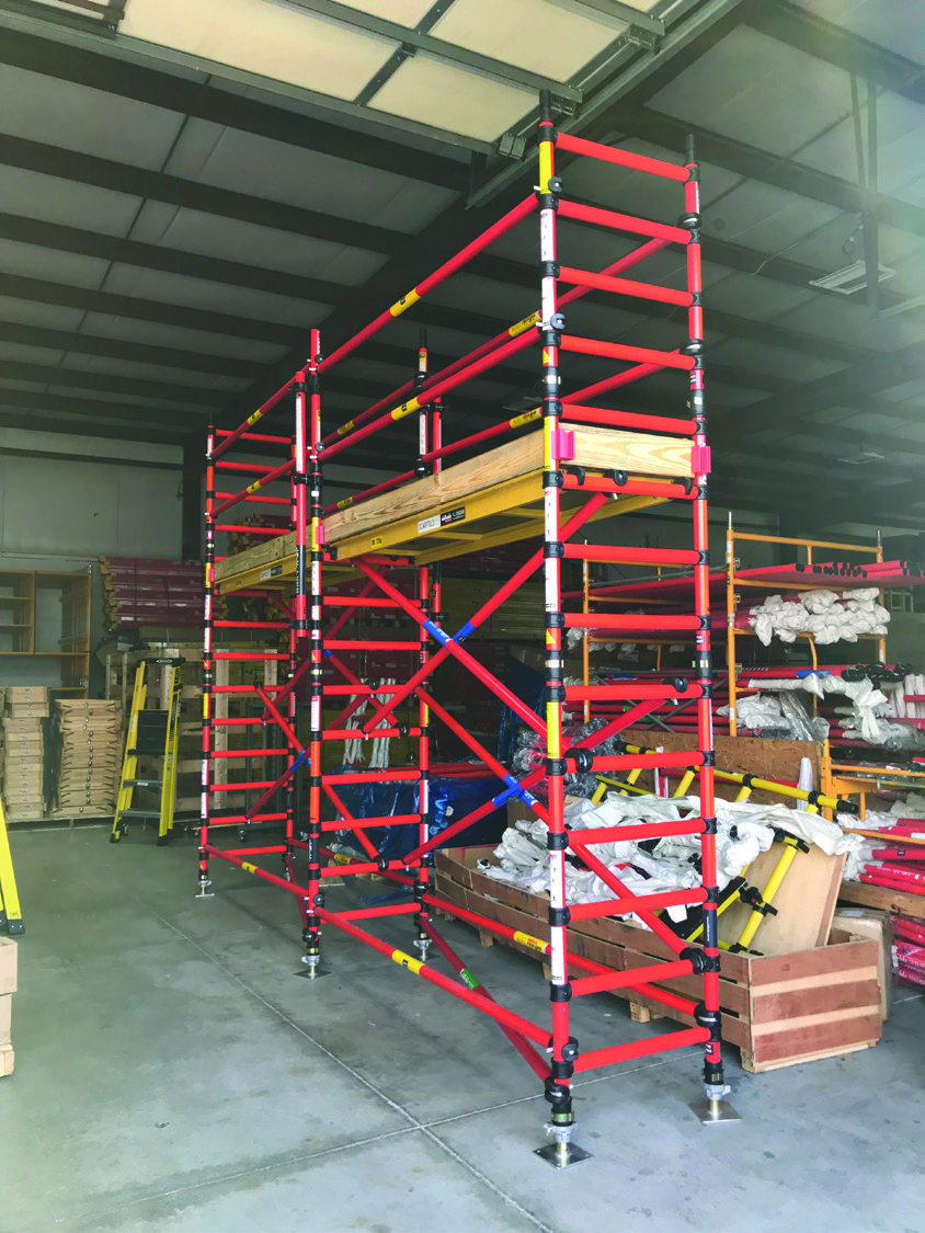 Mobile fiberglass scaffold tower inside a workshop